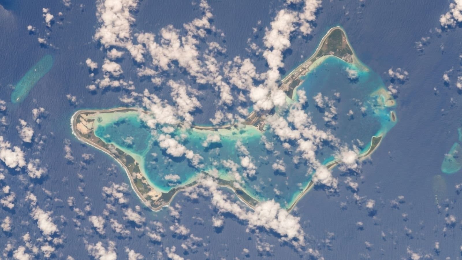Satellite view of the Diego Garcia military base in the Indian Ocean, showing the strategic atoll’s runway and lagoon. This remote joint US-UK facility, located 4,000 kilometers from Iran, became a focal point of regional escalation in March 2026 following an unprecedented long-range missile attempt.